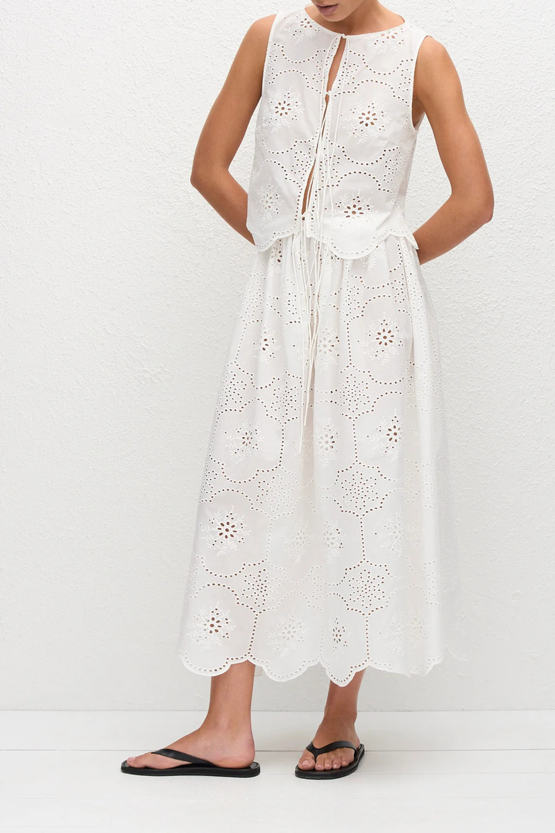 front profile model wearing Broderie Tie Top white Delicate floral broderie
Scalloped hem finish
Open tie front
Sleeveless Blouse
100% Cotton
