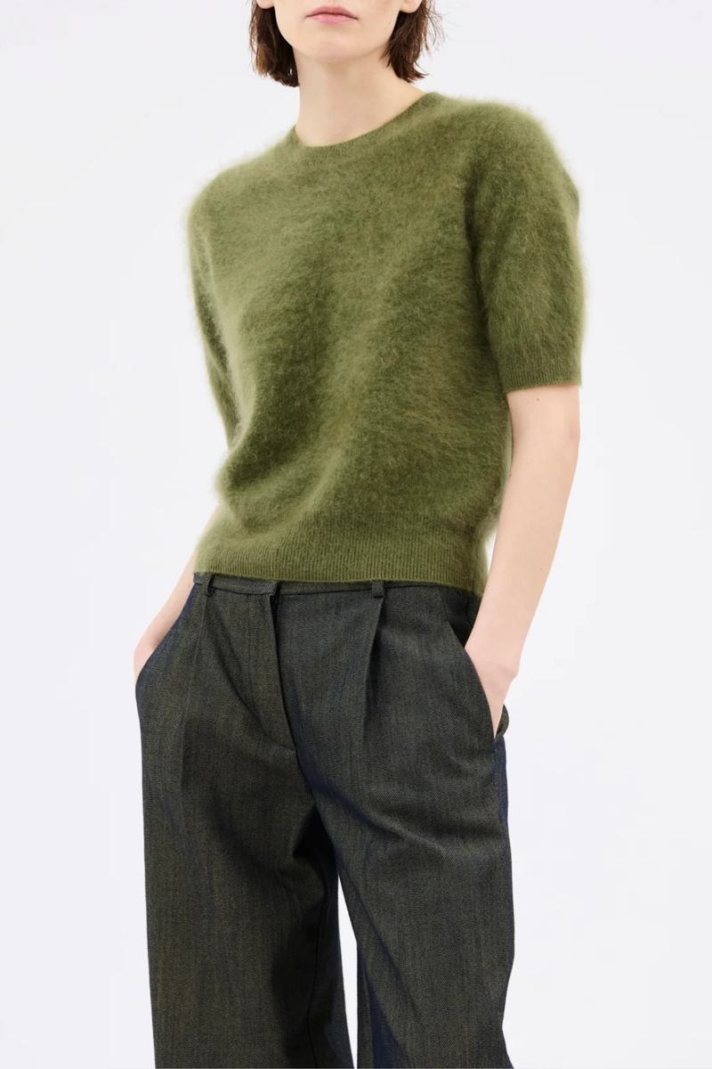 front profile model wearing  Brushed Cashmere Short Sleeve Sweater moss green High ribbed collar