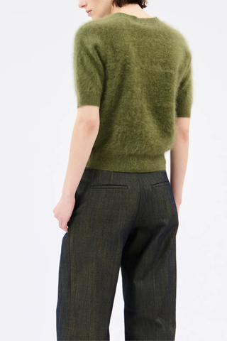 back profile model wearing  Brushed Cashmere Short Sleeve Sweater moss green High ribbed collar