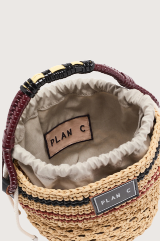 inside close up of Bucket Straw Bag natural Woven straw bucket bag
Contrast striped pattern
Braided handle
Signature logo patch
