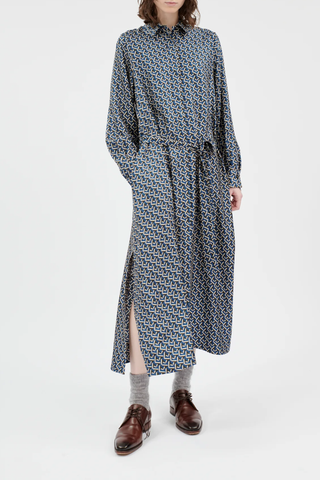 front profile model wearing Button Down Long Sleeve Silk Dress admiral blue geometric mini pattern attached waist tie high side slit hidden button closure midi length