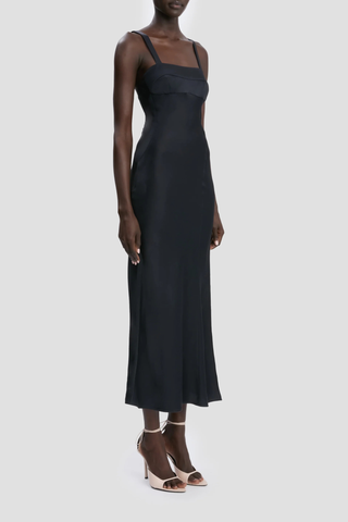 side profile model wearing Cami Dress With Side Slit navy Midi length
Cut on the bias
Self straps
Concealed zip with hook and  eye closure
Curved side-seam split
Skirt side split