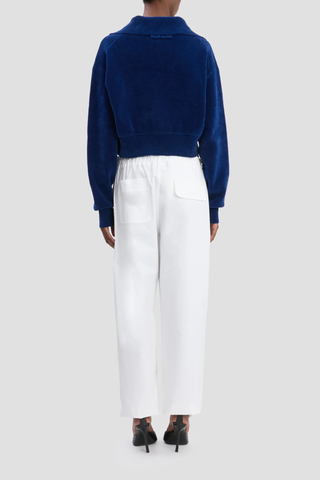 back profile model wearing Cargo Print Trouser White Printed viscose twill fabrication
Utilitarian cargo style
Elasticated waistband with waist ties
Leg cuffs with ties
Irregular pocket design
Back welt pocket with contrast stitching