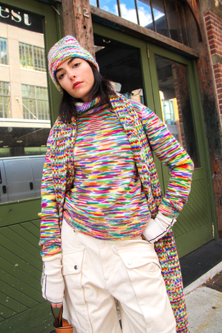 model wearing Cashmere Long sleeve Crew Pullover with multi color stripe pattern