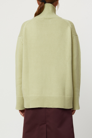 back profile model wearing Cashmere T-neck Sweater Cashmere T-neck Sweater pistachio, green Ribbed turtleneck, 
Ribbed cuff and hem, Relaxed fit