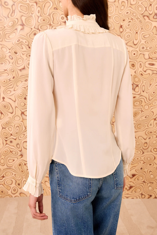 back profile model wearing Catroux Silk Blouse pearl white with ruffle neck and necktie