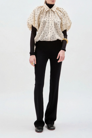 front profile model wearing Charlie Polka Dot Shirt Black/Beige Gathered neckline
Opens into its voluminous, relaxed body
Mid-length puff sleeves
Made in New York
100% Cotton Voile&nbsp;