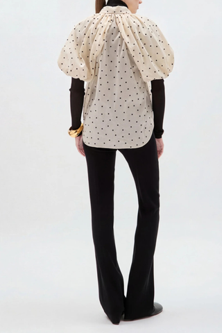 back profile model wearing Charlie Polka Dot Shirt Black/Beige Gathered neckline
Opens into its voluminous, relaxed body
Mid-length puff sleeves
Made in New York
100% Cotton Voile&nbsp;