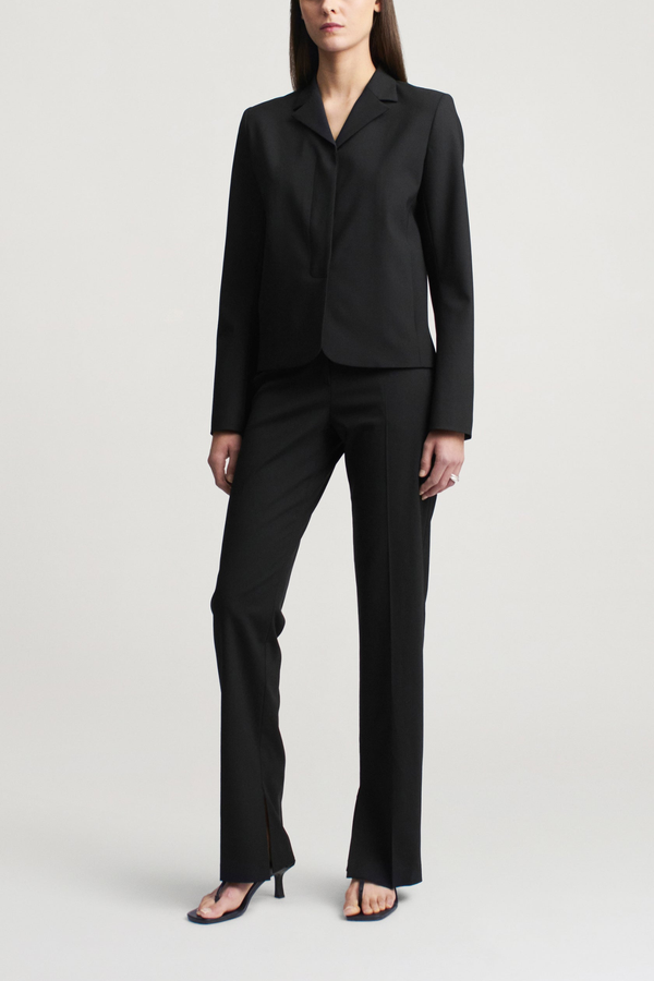 front profile model wearing Charlie Tropical Wool Long Trouser black Slim leg
Straight tailored trouser
Tropical wool suiting
Split hem
Mid-rise
Extended hook
Button tab closure at the waist
Belt loops
Side seam pockets
Sharp center front crease
Single back welt pocket