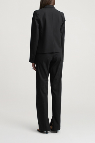 back profile model wearing Charlie Tropical Wool Long Trouser black Slim leg
Straight tailored trouser
Tropical wool suiting
Split hem
Mid-rise
Extended hook
Button tab closure at the waist
Belt loops
Side seam pockets
Sharp center front crease
Single back welt pocket