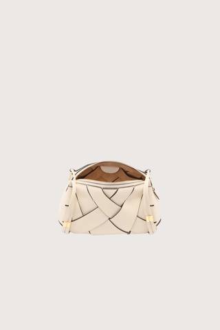 inside view of Charlotte Camera Bag Cowrie cowrie white
Hand-woven
Thick tubular strap
Worn crossbody or on the shoulder
Suede interior
Calfskin nappa leather
Hammered antique brass sliders
Zipper along top