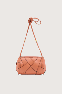 front profile Charlotte Camera Bag Rose 
Hand-woven
Smooth white leather
Thick tubular strap
Worn crossbody or on the shoulder
Suede interior
Calfskin nappa leather
Hammered antique brass sliders
Zipper along top