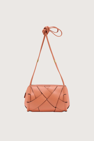 front profile Charlotte Camera Bag Rose 
Hand-woven
Smooth white leather
Thick tubular strap
Worn crossbody or on the shoulder
Suede interior
Calfskin nappa leather
Hammered antique brass sliders
Zipper along top