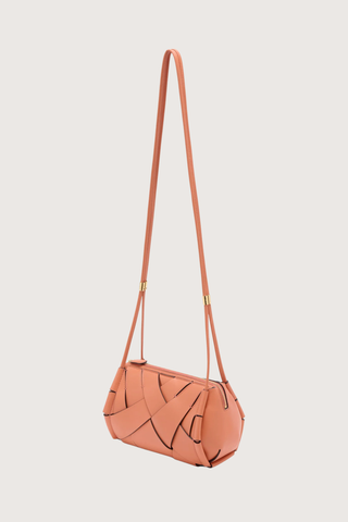 side profile Charlotte Camera Bag Rose 
Hand-woven
Smooth white leather
Thick tubular strap
Worn crossbody or on the shoulder
Suede interior
Calfskin nappa leather
Hammered antique brass sliders
Zipper along top
