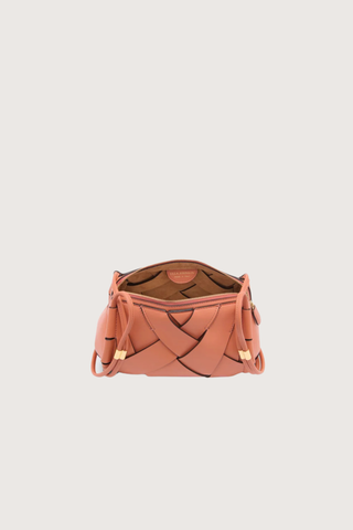 inside view of Charlotte Camera Bag Rose 
Hand-woven
Smooth white leather
Thick tubular strap
Worn crossbody or on the shoulder
Suede interior
Calfskin nappa leather
Hammered antique brass sliders
Zipper along top