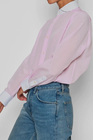 side profile model wearing Chemise De Garcon Shirt pink and white Rounded collar
Pale pink silk crêpe-de-chine
Silk base, contrasted by the crisp white cotton poplin collar and cuffs
Straight cut - classic fit
Back yoke with pleat
Square cuff
Mother-of-pearl buttons
90% silk crepe de chine/10% two-ply cotton poplin