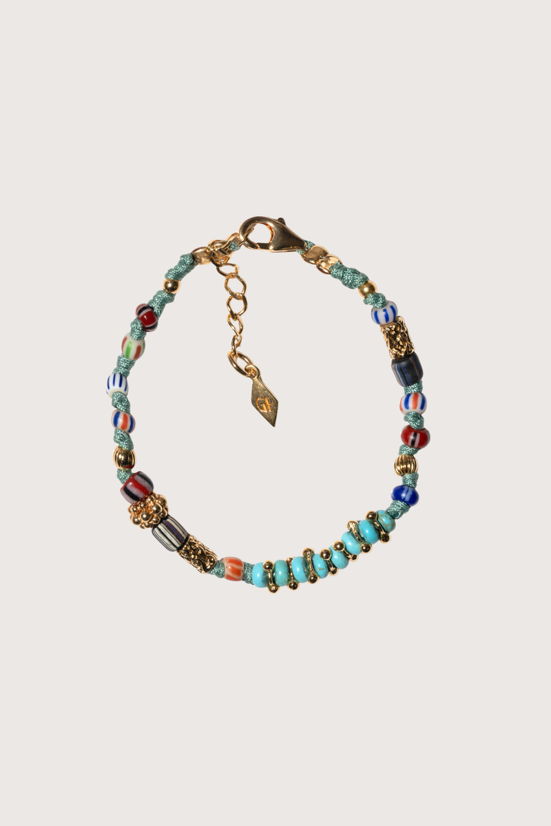 flat lay Chergui Bracelet Light Turquoise Hand crocheted bracelet with gold filled beads, turquoises and African beads
Gold-plated and effortless braided cords and multicolored stones
Dimensions: 16cm