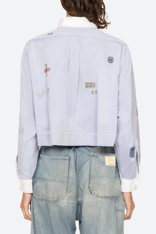 back profile model wearing Claira Embroidered Button Down light blue Long sleeve shirt
Cropped oxford button-down
Contrasting collar and cuffs
Detailed embroidery 100% cotton