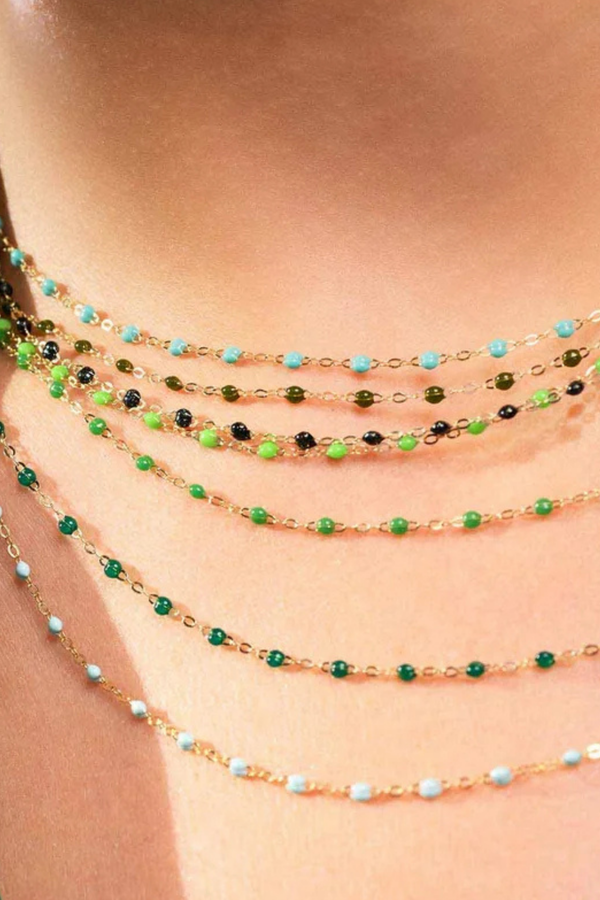 model wearing Classic Gigi Necklace 16.5" 18K Yellow Gold Emerald Emerald resin jewels
varying 16.5" options and solid black jewels
16.5" chain with adjustable clasp at 16.1"