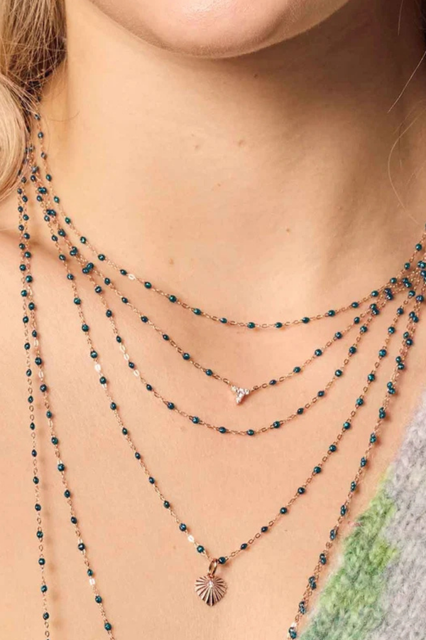 model wearing Classic Gigi Necklace 16.5" 18K Yellow Gold Jungle Jungle blue resin jewels
varying 16.5" options and solid black jewels
16.5" chain with adjustable clasp at 16.1"