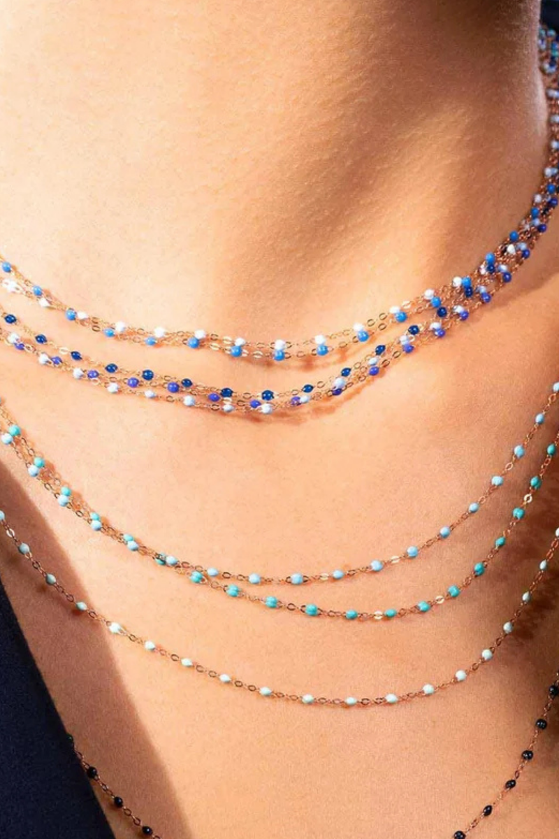 model wearing Classic Gigi Necklace 16.5" 18K Yellow Gold Turquoise Turquoise resin jewels
varying 16.5" options and solid black jewels
16.5" chain with adjustable clasp at 16.1"