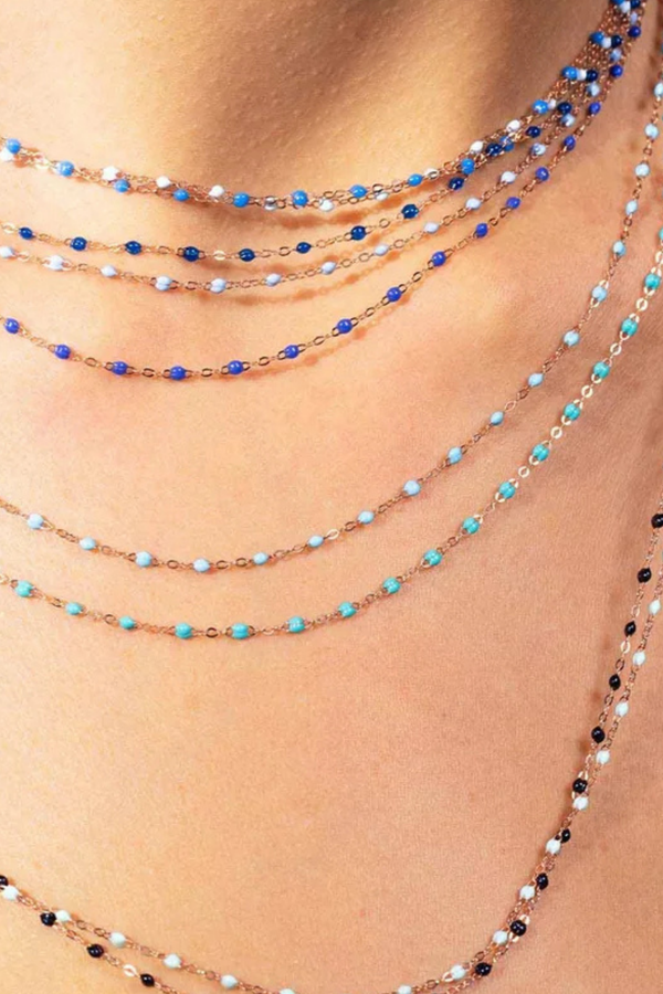 model wearing Classic Gigi Necklace 16.5" 18K Yellow Gold Turquoise Green Turquoise Green resin jewels
varying 16.5" options and solid black jewels
16.5" chain with adjustable clasp at 16.1"