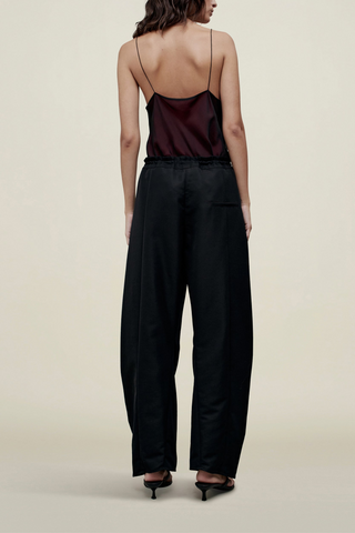 back profile model wearing Clemence Pant black relaxed fit Sculptural horseshoe shaped
Pleated front construction
Patch pocket at front