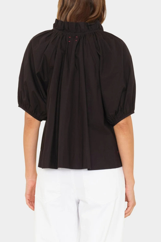 back profile model wearing Clementine Top black Crisp paper poplin
Deep V-neck
Ruffle detailing
Shirred puff sleeves
100% Cotton