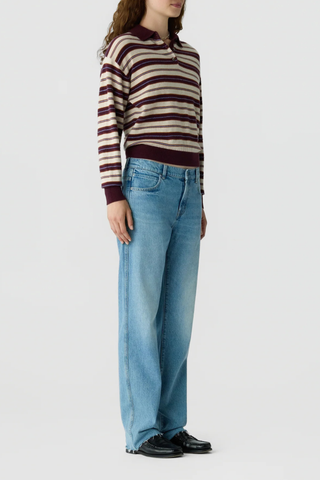side profile model wearing Collegiate Stripe Polo fig combo 
Knit from light-weight 100% cashmere
Relaxed fit
Rib hem and cuff trim
Polo collar in rib stitch
Front three button placket closure
