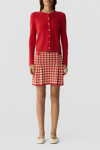 front profile model wearing Compass Jane Cardigan scarlet red LIGHT-WEIGHT POPCORN STITCH CARDIGAN
HIGH CUFF RIB TRIM AT SLEEVE
RIB HEM TRIM
JERSEY TUBULAR NECK TRIM
FRONT BUTTON CLOSURE
GIR BRANDING AT BACK NECK
100% CASHMERE