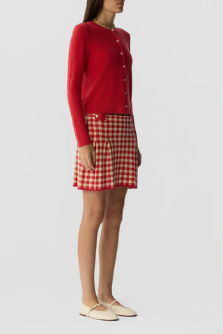 side profile model wearing Compass Jane Cardigan scarlet red LIGHT-WEIGHT POPCORN STITCH CARDIGAN
HIGH CUFF RIB TRIM AT SLEEVE
RIB HEM TRIM
JERSEY TUBULAR NECK TRIM
FRONT BUTTON CLOSURE
GIR BRANDING AT BACK NECK
100% CASHMERE