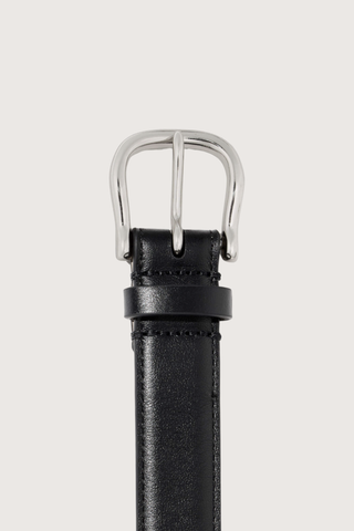 close up buckle detail for  Amelia Belt black 25mm wide belt
Italian smooth leather
Lightweight suede lining in a contrasting natural hue
Bombe construction
Custom silver-tone hardware
100% Calfskin Leather