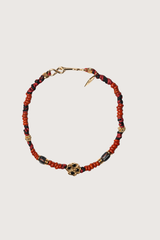 flat lay Coralo Triple Handwoven bracelet Red and gold filled beads