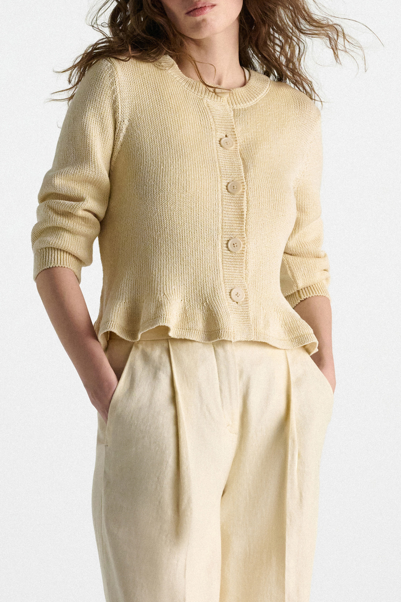 front profile model wearing Cotton Candy Cardigan icy lemon yellow Fun flounce effect at the hemline
100 % Cotton
Cropped
Button front
Flared drape
Round neckline
