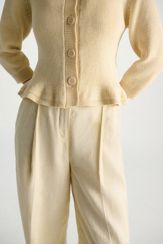 close up hem detail for Cotton Candy Cardigan icy lemon yellow Fun flounce effect at the hemline
100 % Cotton
Cropped
Button front
Flared drape
Round neckline