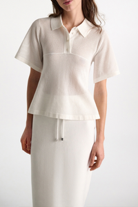 front profile model wearing Cotton Coolness Mesh Top white Knit top with polo collar and empire waist
Sporty stretch cotton pointelle
A special engineered knit technique creates flared volume from the empire seam to hem