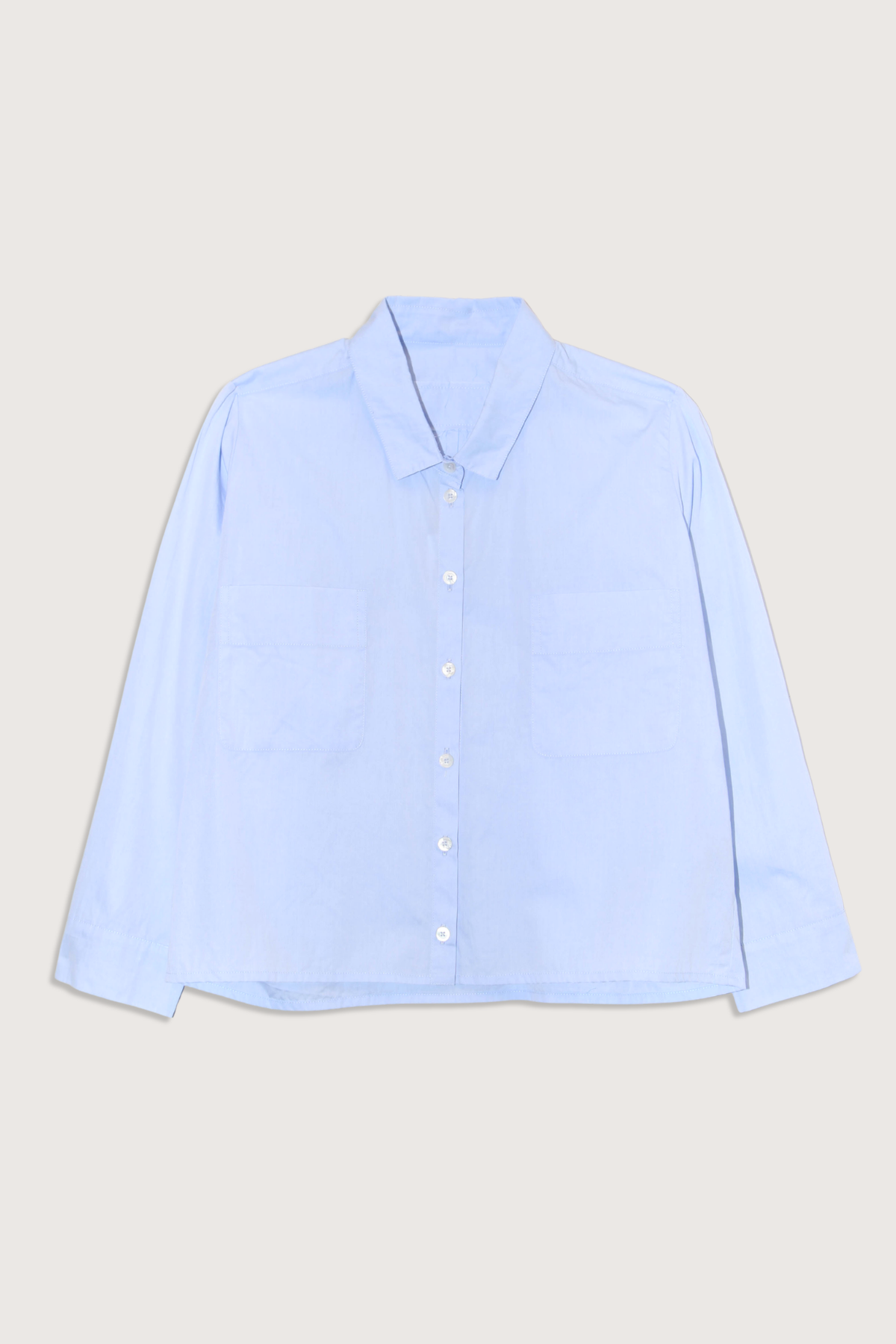 flat lay Cotton Crop Shirt With Pockets  Light Blue
Front chest pocket
Button front closure
Classic collar