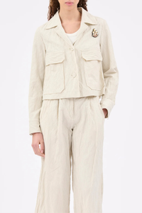 front profile model wearing Crinkled Pin Stripe Jacket ivory Utility-style jacket
Wide lapels
Patch pockets with side openings
Includes a handmade rhinestone brooch