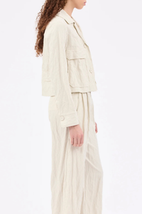 side profile model wearing Crinkled Pin Stripe Jacket ivory Utility-style jacket
Wide lapels
Patch pockets with side openings
Includes a handmade rhinestone brooch