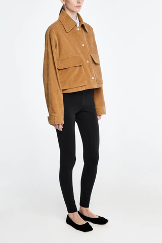 side profile model wearing Cropped A-Line Cord Jacket caramel Two-way entry patch flap pockets at the front
Gently flared swing hem
Fastened with brushed German gold snaps
100% organic cotton Japanese corduroy