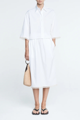 front profile model wearing Cropped Lace Shirt white delicate, ivory French lace detail at the cuff
Shorter, cropped length
Center box pleat at the back
Wide, short sleeves
Organic Cotton sateen