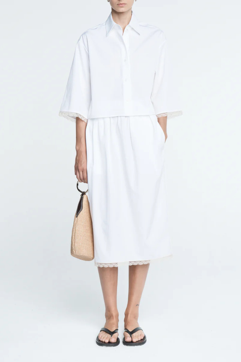front profile model wearing Cropped Lace Shirt white delicate, ivory French lace detail at the cuff
Shorter, cropped length
Center box pleat at the back
Wide, short sleeves
Organic Cotton sateen