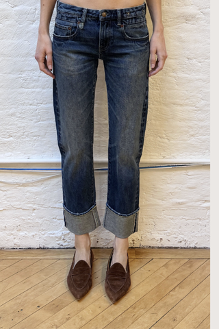 front profile model wearing Cuffed Boy Straight Selvedge Blue Jean Low rise
Slim straight
Cropped leg
Comfort stretch Japanese selvedge indigo denim. 13 oz, 98/2
Dark indigo wash
Heavy wear pattern