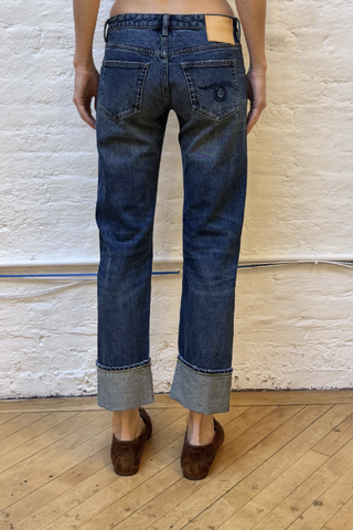 back profile model wearing Cuffed Boy Straight Selvedge Blue Jean Low rise
Slim straight
Cropped leg
Comfort stretch Japanese selvedge indigo denim. 13 oz, 98/2
Dark indigo wash
Heavy wear pattern