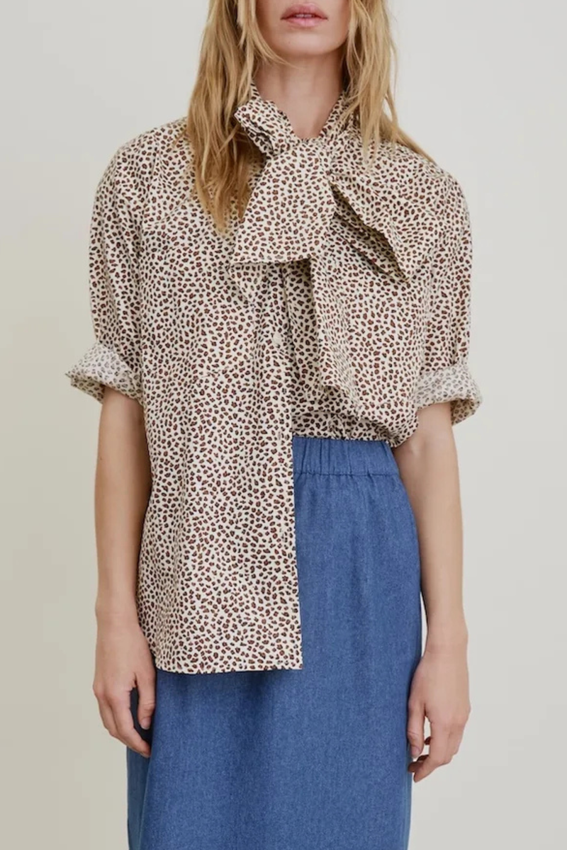 front profile model wearing Dear Polly With Tie Shirt cheetah print Button front
Long neck ties: keep them loose or tie them off kilter in a sloppy bow.
Two front pockets and long-ish shaped hemline 
100% Cotton Poplin