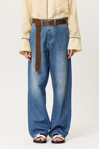 front profile model wearing Denim Trouser With Brown Belt indigo blue cotton Wide leg blue jeans
Belt included
Oversized pockets