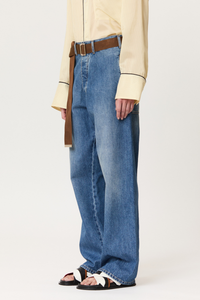 side profile model wearing Denim Trouser With Brown Belt indigo blue cotton Wide leg blue jeans
Belt included
Oversized pockets