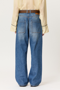 back profile model wearing Denim Trouser With Brown Belt indigo blue cotton Wide leg blue jeans
Belt included
Oversized pockets