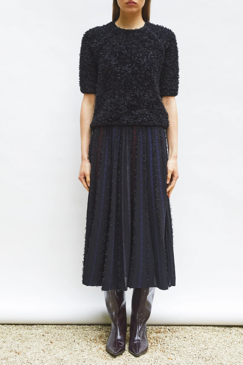 front profile model wearing  Desperado Textured Elbow Top Black satin-stitched tulle yarn