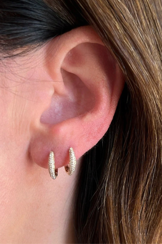 model wearing Diamond Dome Huggie  Earring (Pair) yellow gold 
.20 carats of pavé diamonds

Outer diameter: 12 mm
Inner diameter: 10 mm
Huggie width at widest point: 2.5 mm
Finished with a latch closure